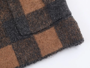 Close-up of thick grey and brown plaid knit fabric texture on a winter coat