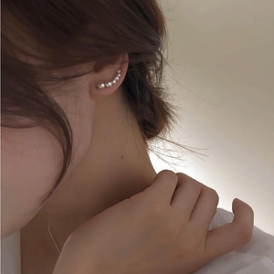 Detailed view of silver gradient beads earrings worn on ear showing elegant curved design
