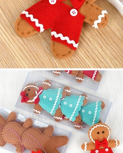 Detail of fabric gingerbread man dolls with red overalls and mint green dress ornaments