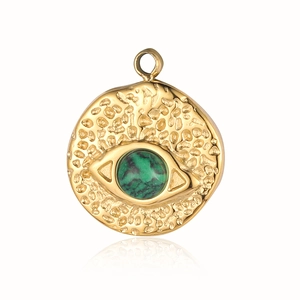 Macro view of a gold-plated stainless steel evil eye pendant with green natural stone inlay