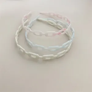 Set of three colorful chain link acetate headbands in marble pink, blue and cream white