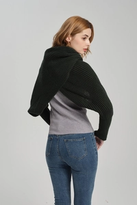 Detail of dark green ribbed knit sleeve scarf showing crossover back design on model