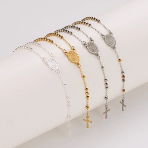 Vintage Virgin Mary medallions and cross pendants on gold and silver beaded chain bracelets