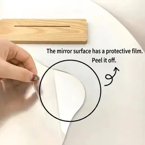 Irregular acrylic makeup mirror with wooden base and protective film being peeled off