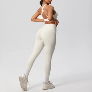 Detail of creamy white yoga set showing criss-cross back sports bra and high waist leggings
