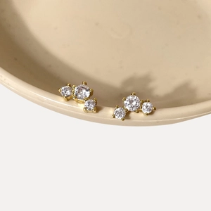 Dettaglio ravvicinato di orecchini a lobo placcati oro 18k con scintillanti zirconi