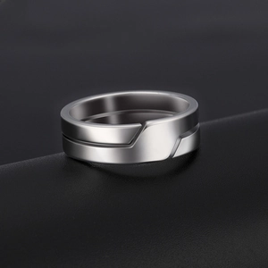 Macro shot of silver stainless steel ring with geometric facets and matte metallic finish
