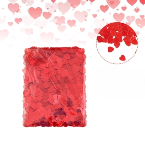 Macro view of glittering red heart-shaped sequins in clear plastic packaging