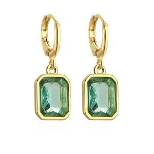Detailed macro view of 18K gold plated earrings featuring emerald green rectangular stones