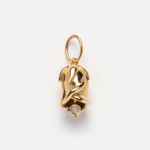 Macro shot of tulip bud pendant with birthstone in gold plating on white background