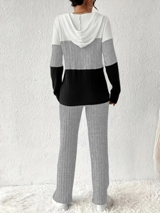 Detail showing grey and white color-block hoodie back with ribbed knit texture