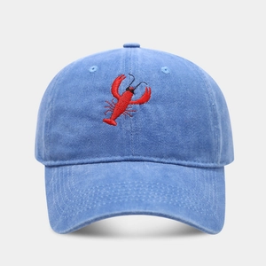 Close-up of red lobster embroidery on washed blue vintage cotton baseball cap