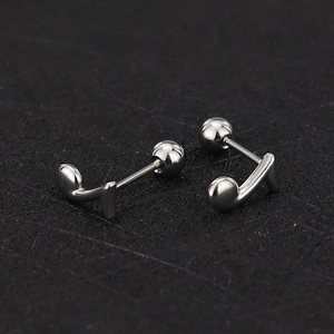 Macro detail of silver musical note stud earrings with smooth ball-back screw closures