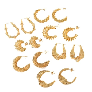 Set of seven pairs of 18K gold plated stainless steel twisted hoop earrings on white background