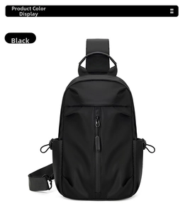 Detail view of black oxford chest bag featuring a vertical zipper and drawstring pockets