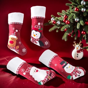 Christmas embroidered stockings featuring Santa and reindeer in festive holiday scenery