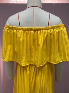Macro detail of vibrant yellow pleated chiffon texture and off-shoulder neckline design
