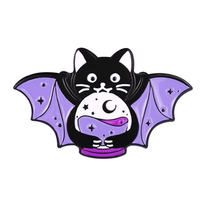 Detail of a dark style wizard cat enamel pin with bat wings holding a crystal ball