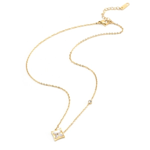 Detail of gold star pendant featuring white mother of pearl and a sparkling rhinestone