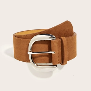 Detail of vintage brown suede wide belt featuring a polished silver D-ring metal buckle