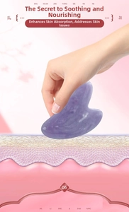 Macro detail of heart-shaped purple jade gua sha board with natural stone texture