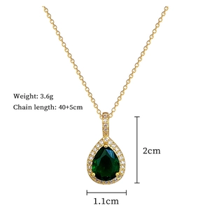 Macro shot showing green zircon drop pendant dimensions with gold chain and white stones