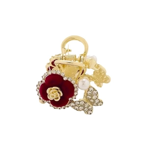 Golden metal hair claw with a red velvet flower, sparkling rhinestones and a white pearl
