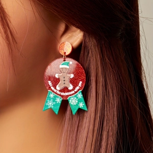 Christmas gingerbread man acrylic earrings with snowflakes and festive green ribbon design