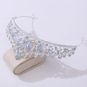 Macro detail of silver bridal tiara featuring blue opalescent gems and rhinestones