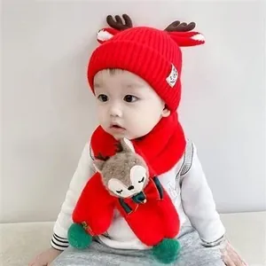 Detail of baby Christmas knit hat and scarf set featuring cute brown deer antlers