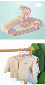 Detail of pink bow plastic hangers for baby clothes with durable thickened design