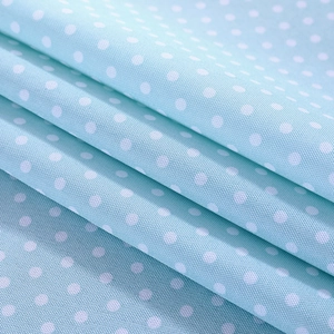Close-up of light blue linen fabric with white polka dots for dust-proof microwave cover