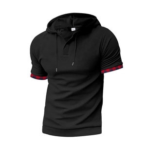 Detail of black hooded t-shirt featuring waffle texture fabric and red plaid sleeve cuffs