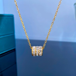 Close-up of titanium steel gold necklace with a triple-row square-cut zircon pendant