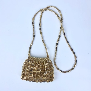 Detailed view of handmade gold sequin mini bag with metallic disc weave and bead chain