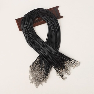 Close-up of bulk black wax cord necklaces with silver lobster clasps and extension chains