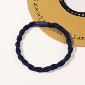 Close-up of deep blue braided elastic hair tie with sturdy cylinder connector