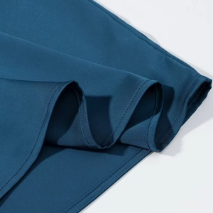 Detailed view of the dark blue satin dress fabric with fine stitching and smooth texture