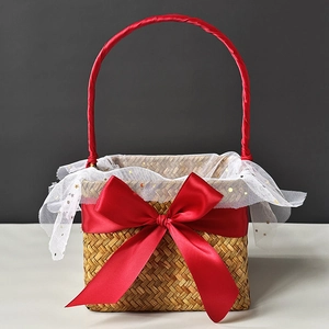 Detail view of woven seagrass gift basket with large red bow and gold star mesh lining