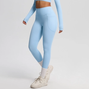 Close-up of high-waisted light blue yoga leggings featuring a functional side pocket