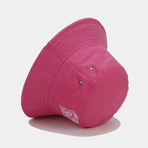 Hot pink canvas bucket hat with white letter embroidery and metal ventilation eyelets