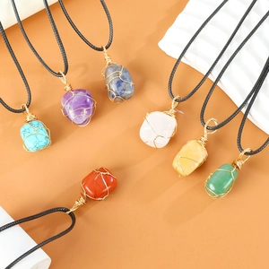 Seven irregular crystal wire wrapped necklaces in various colors with black cords