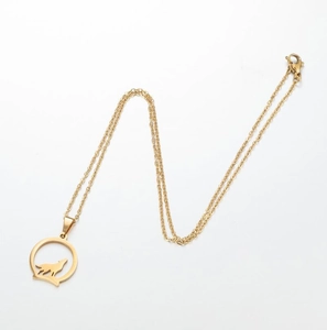 Detailed shot of a gold-toned wolf silhouette pendant necklace with a lobster clasp closure