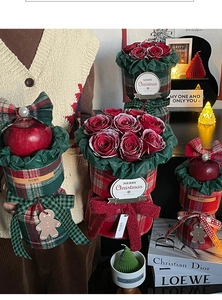 Detailed view of Christmas red rose bouquets in British plaid fabric gift wrapping