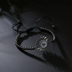 Macro detail of adjustable black beaded bracelet featuring a sunflower crystal pendant