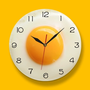 Detailed view of creative fried egg kitchen wall clock with numeric 3D design