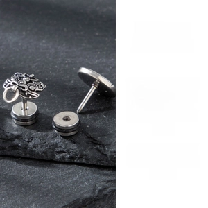 Detailed macro view showing the threaded screw-back closure on a retro stainless steel stud