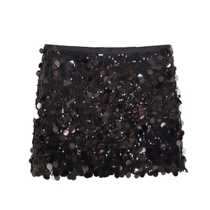 Close-up of black sequin mini skirt showing shimmering texture and detailed stitching