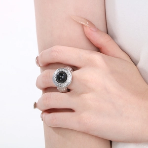 Macro detail of wide lava texture stainless steel ring with black enamel center on finger