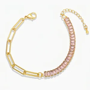Detail of gold paperclip chain and baguette-cut pink zircon stones on women bracelet